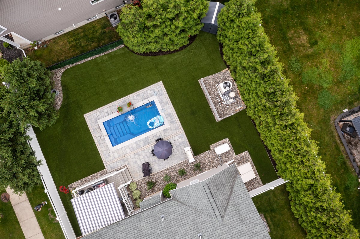 aerial view of a small pool with waterfall and the associated pump system