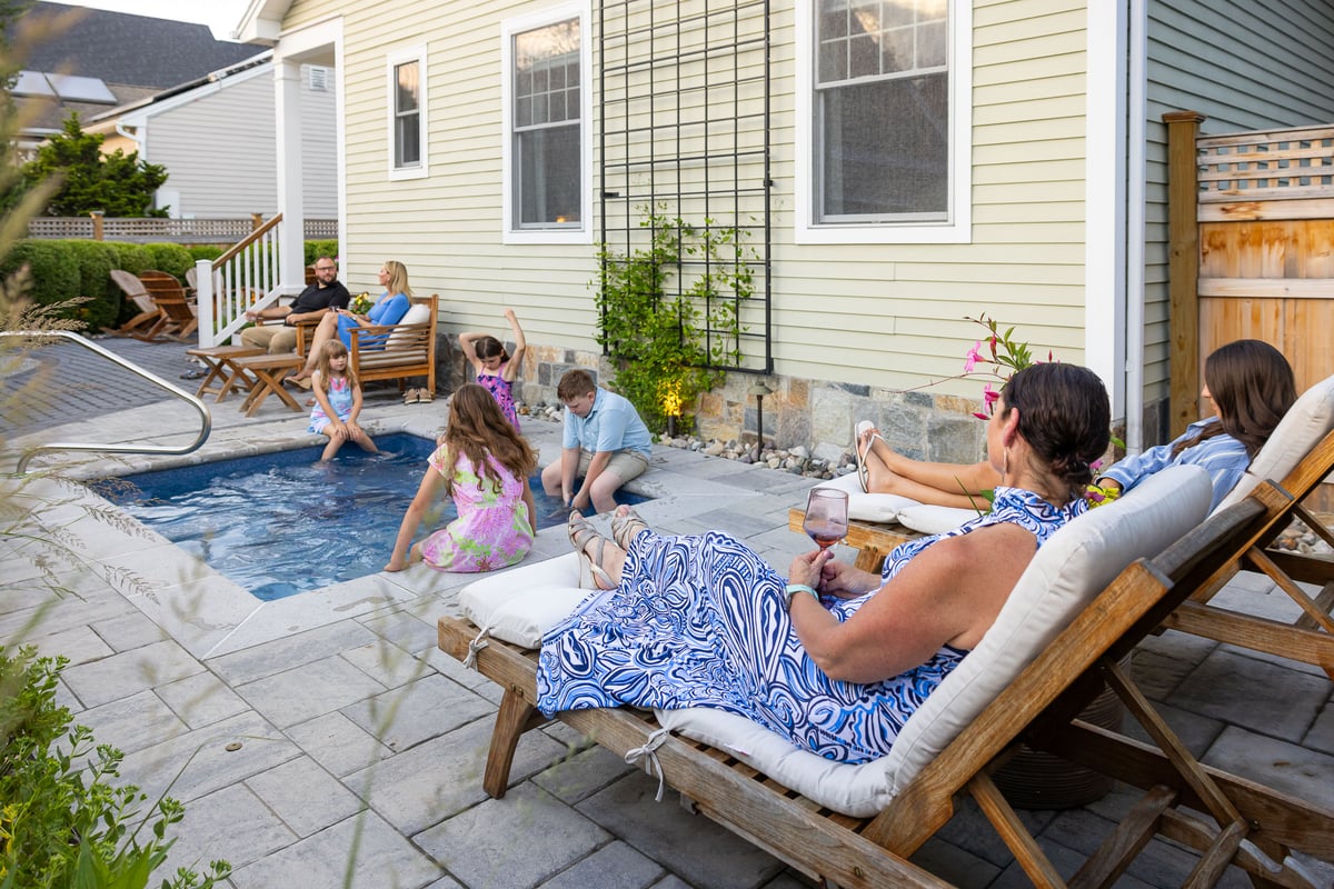 family enjoying a plunge pool in the backyard