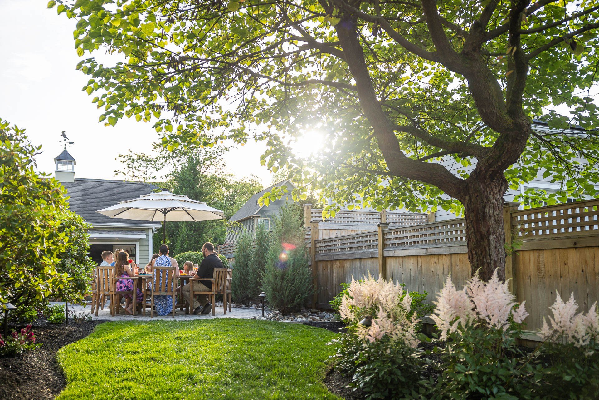 patio space surrounded by grass and planting beds