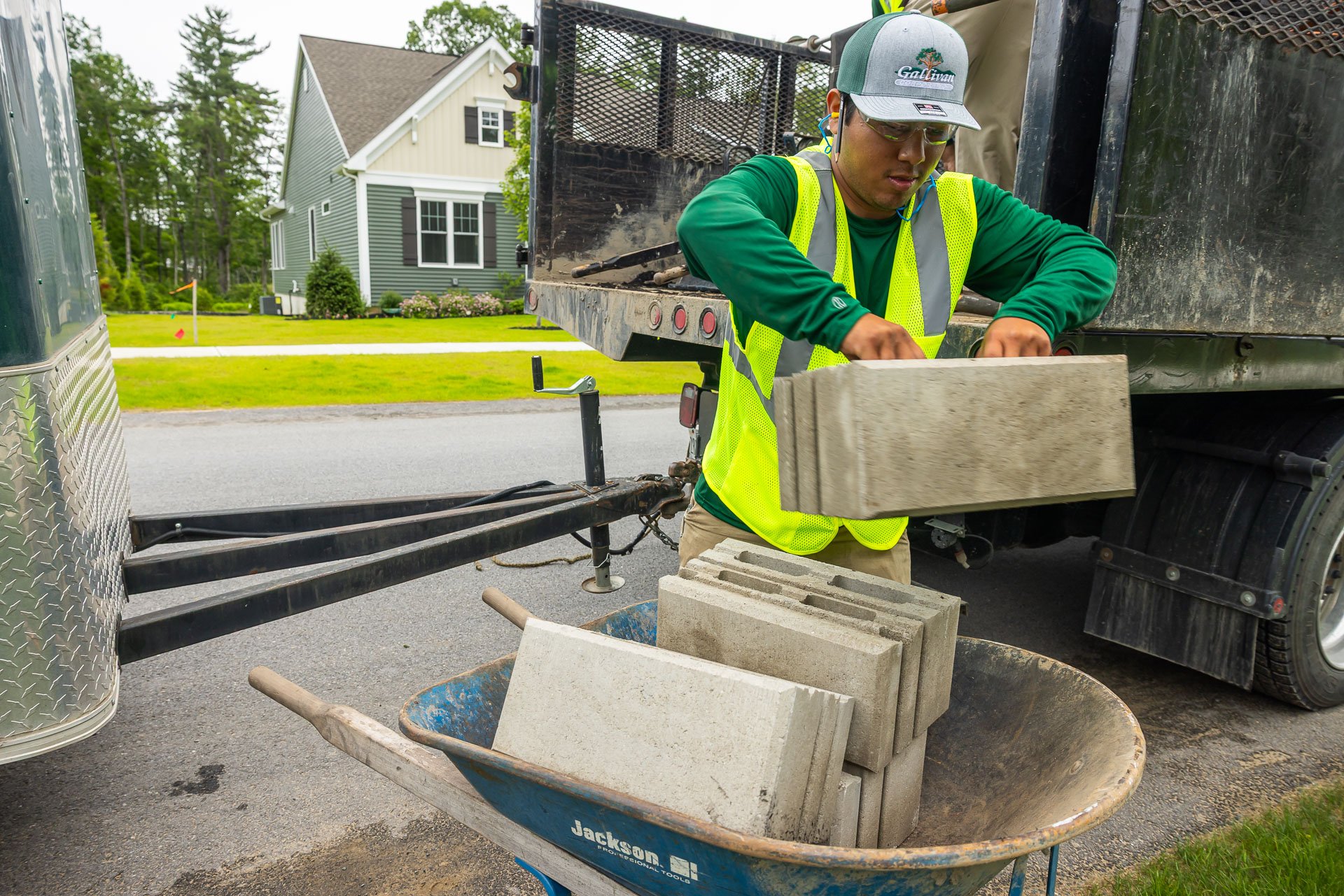 landscape construction crew using landscape blocks to build walls