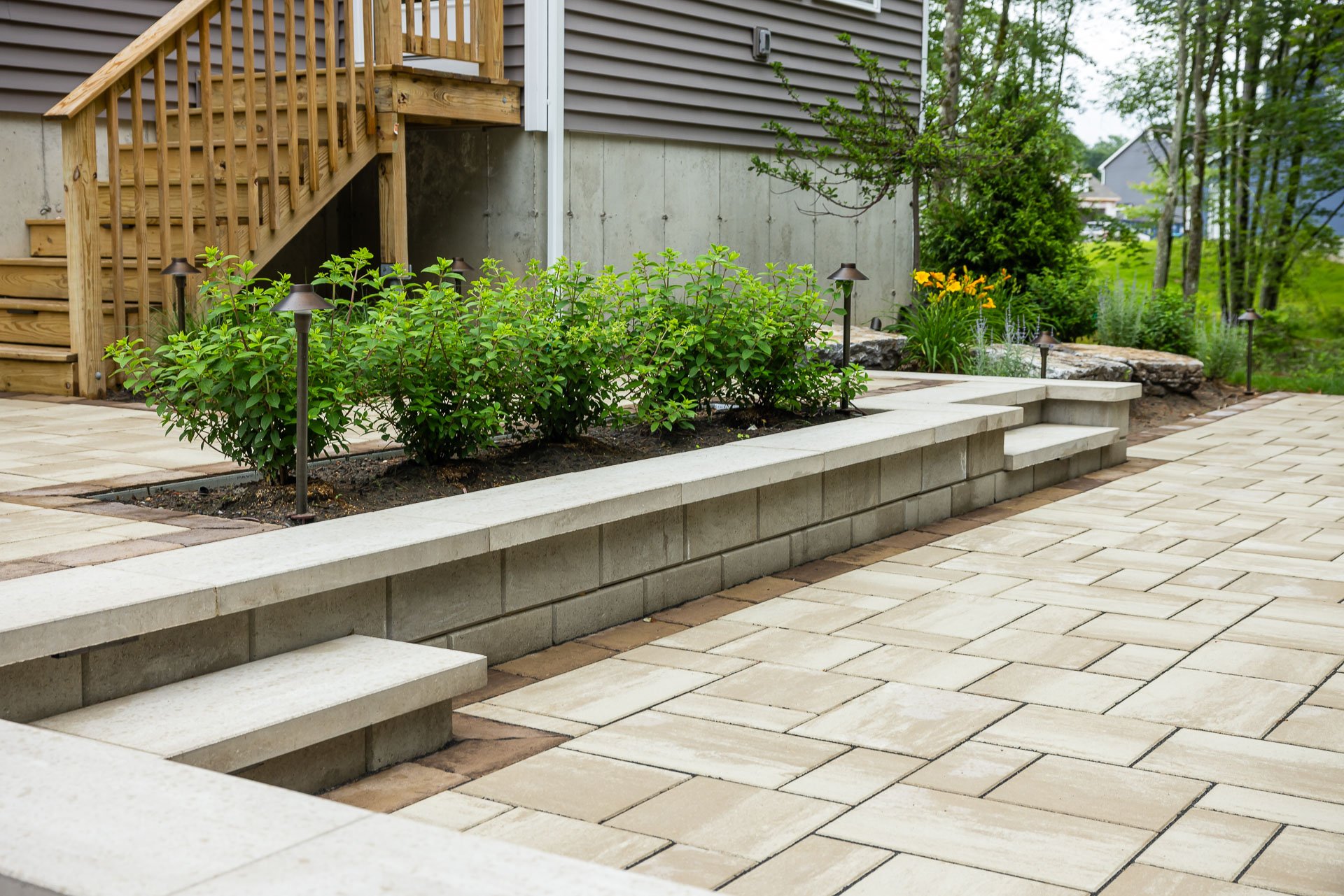 clean lines and colors of a stone patio and retaining wall