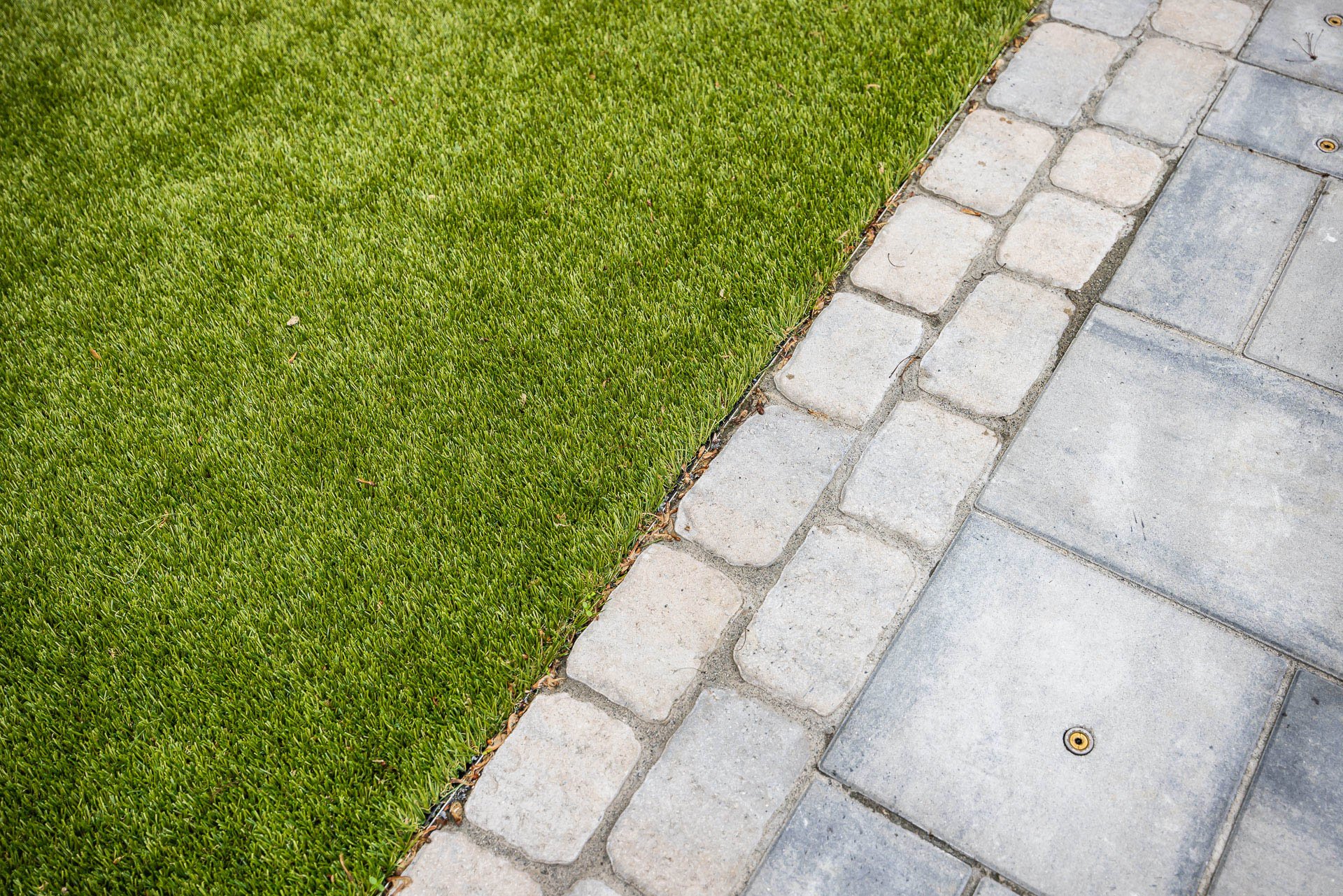 pavers butting up against turf grass