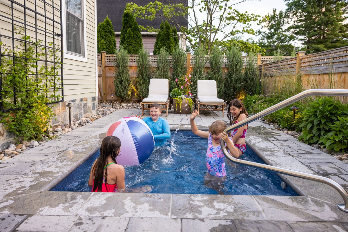 children playing and splashing in a pool