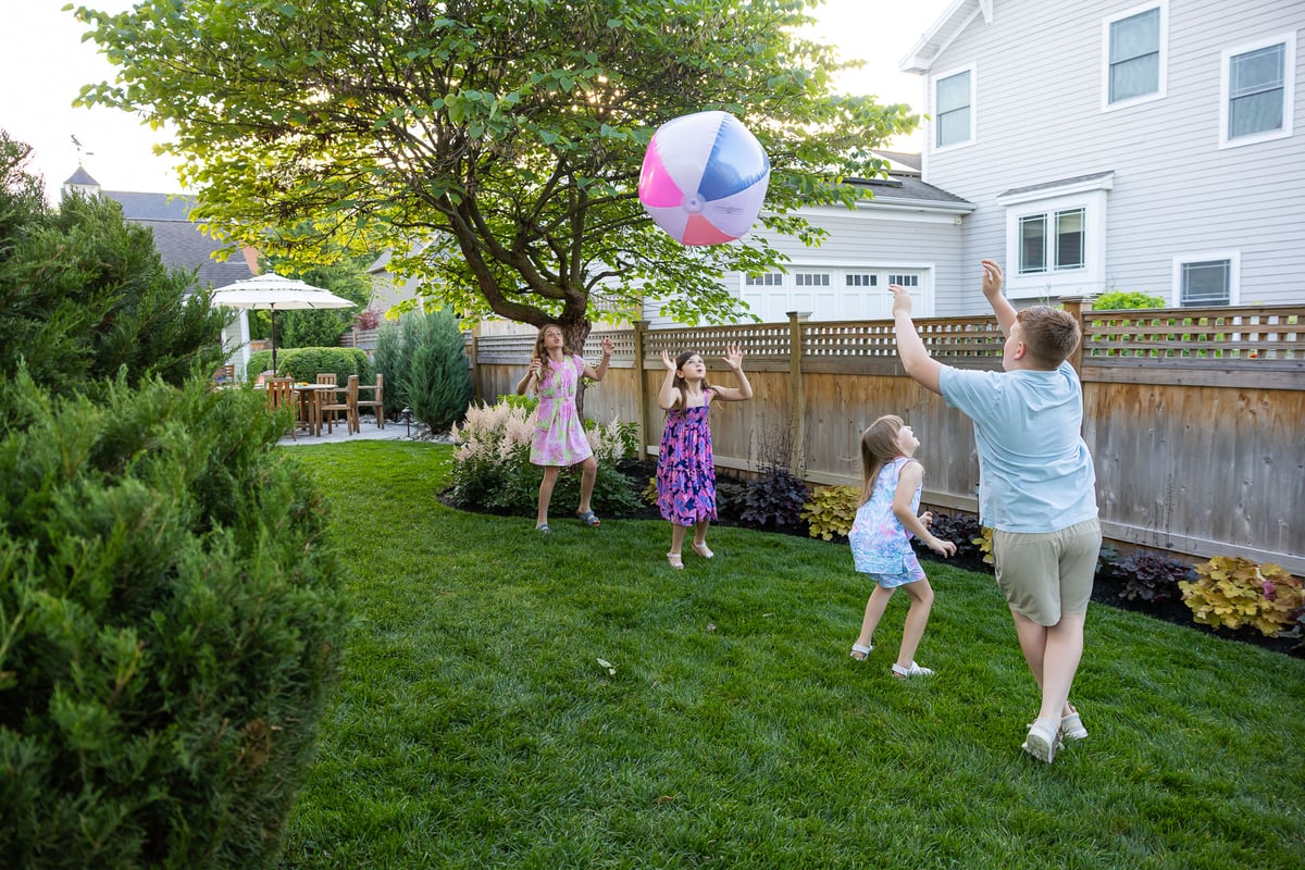 family playing in grassy area