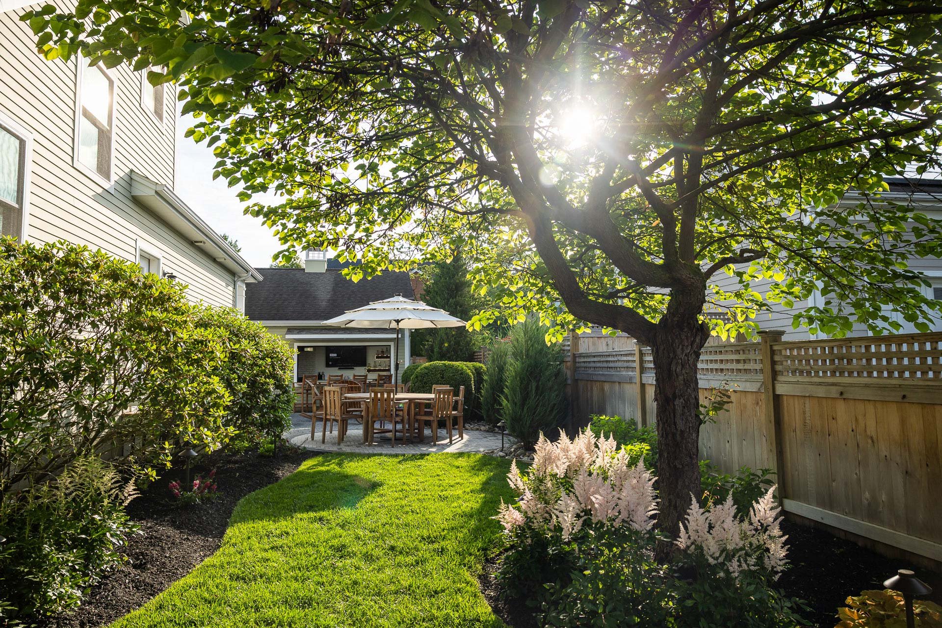 natural area leading into a hardscape patio space