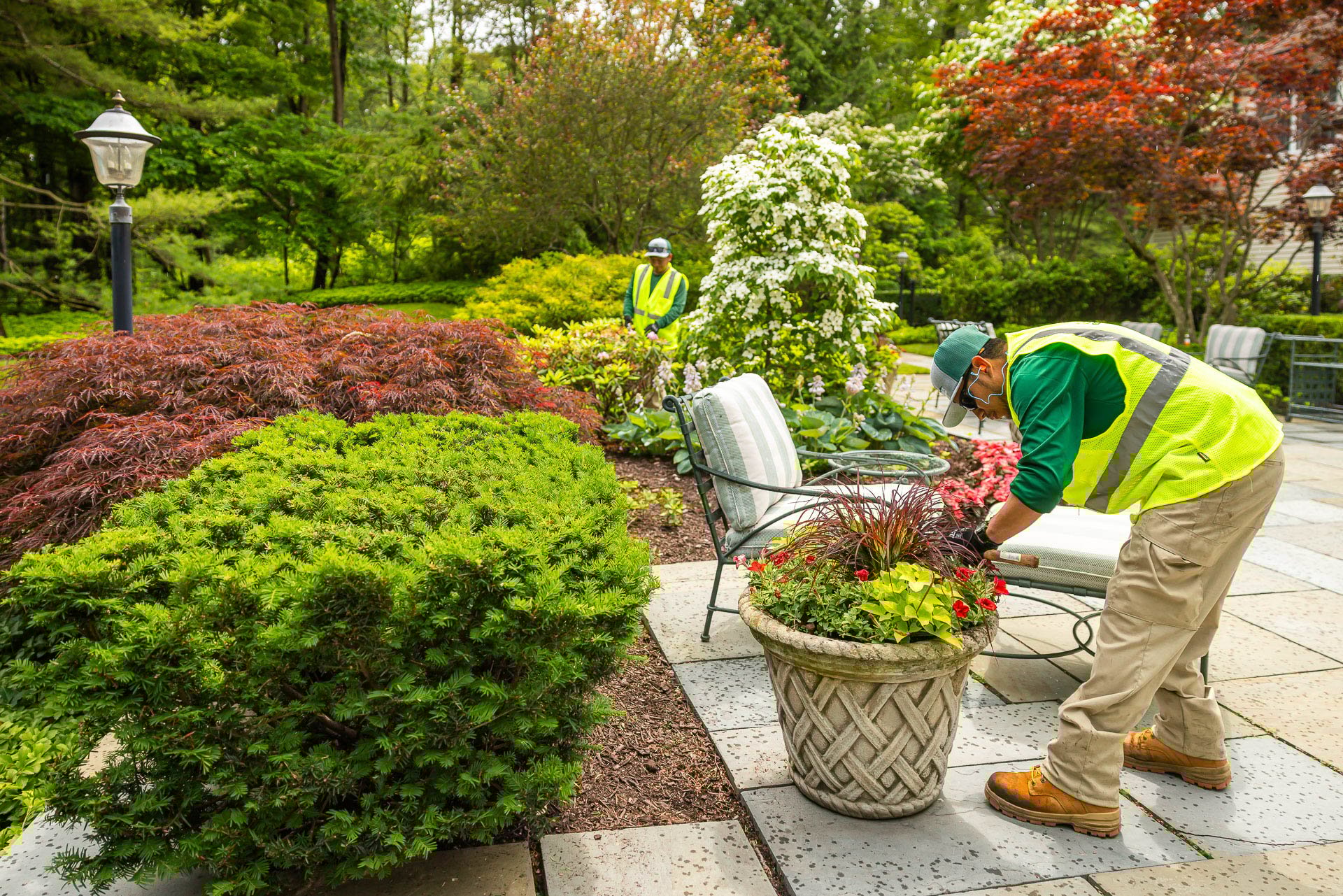 crew maintaining an annual flower pot