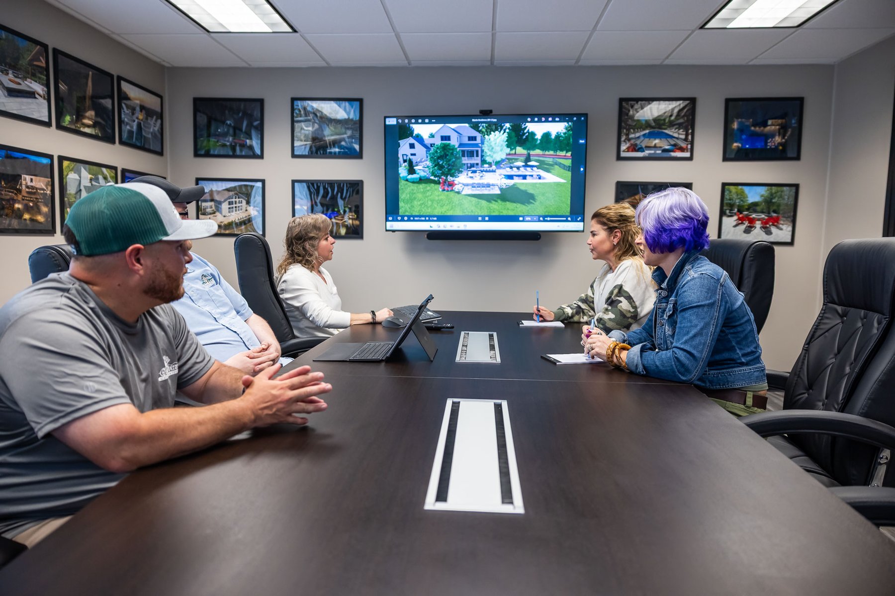 landscape design team reviewing a phased landscape construction plan