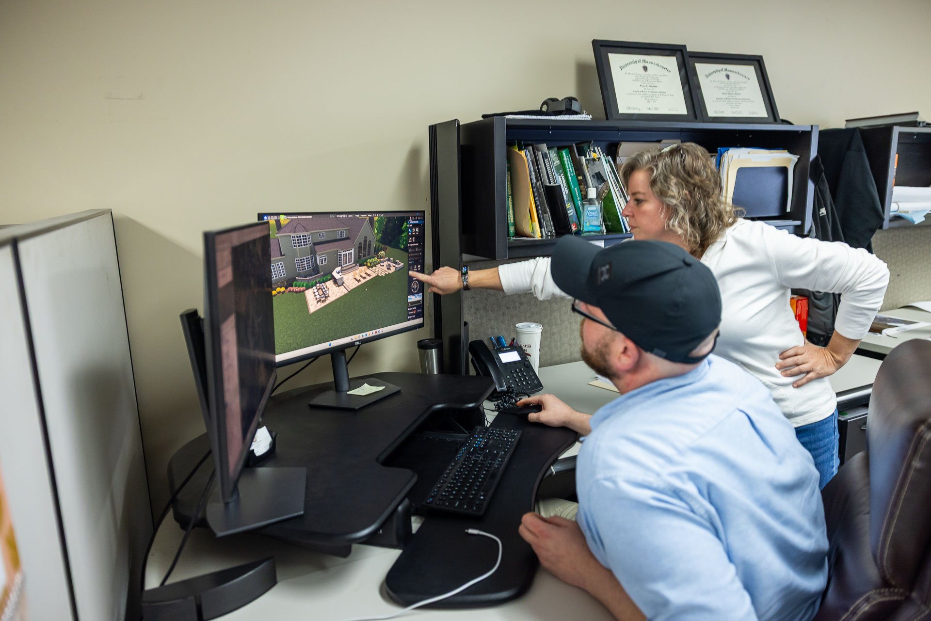 design staff reviewing landscape design model