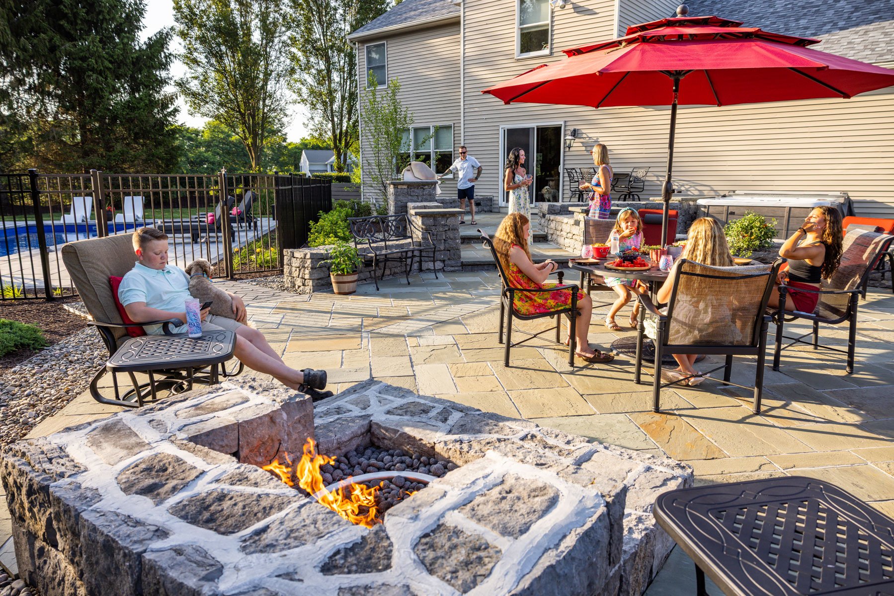 family backyard happy seating table food firepit dog