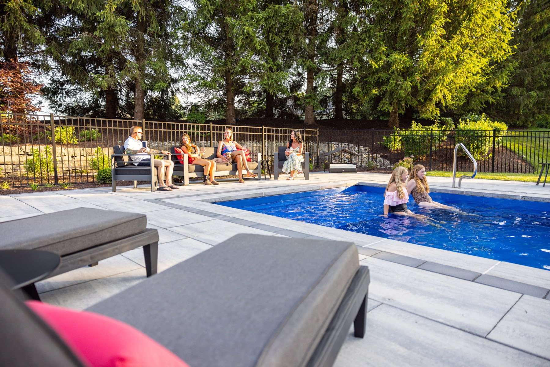family relaxing on a tanning ledge