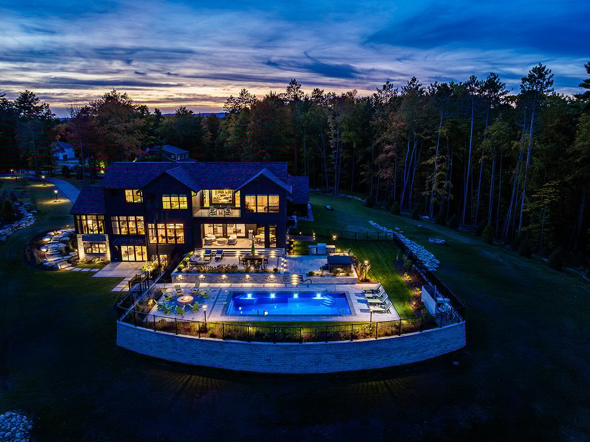 full landscape installation and pool lit up at night