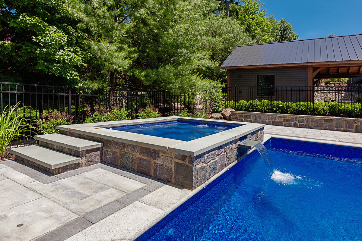 integrated hot tub with an inground pool