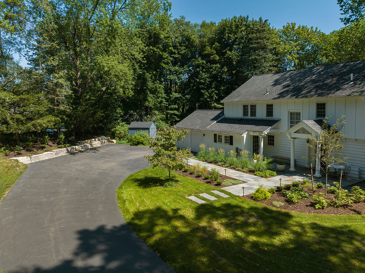 driveway entrance with pathways leading to the front of the home