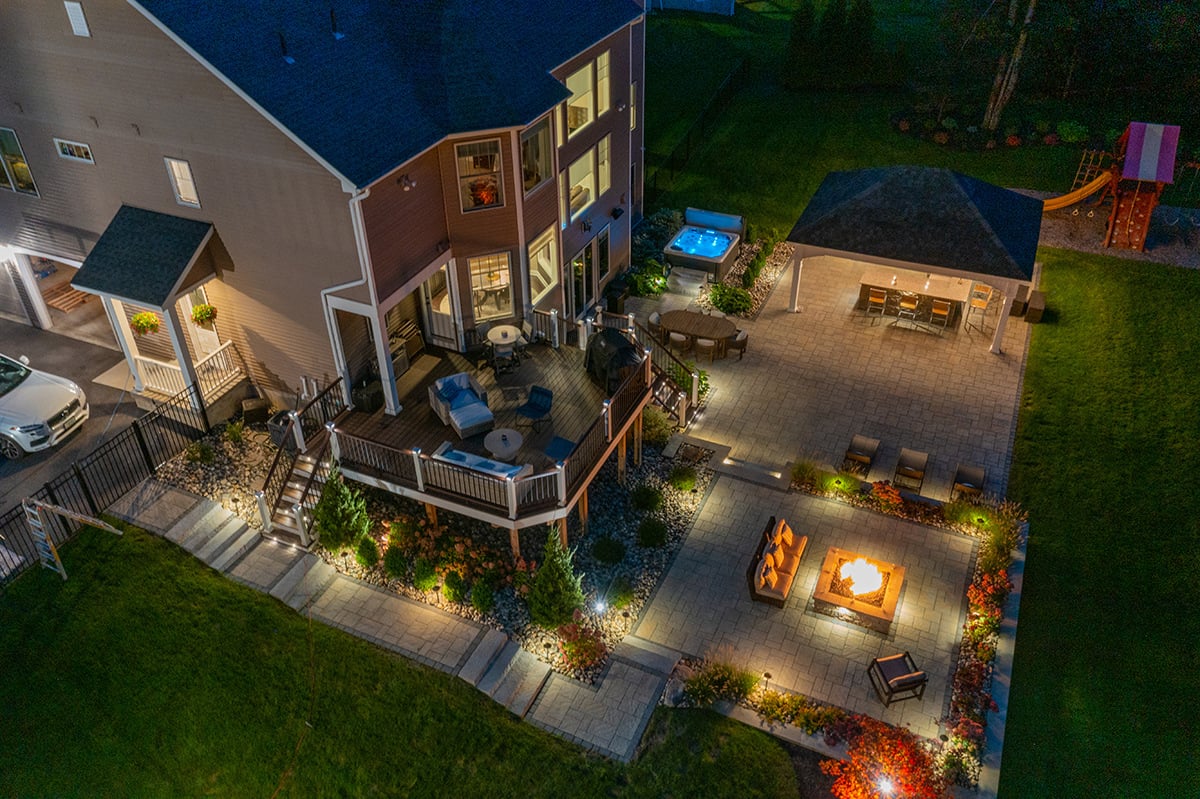 a backyard with landscape lighting