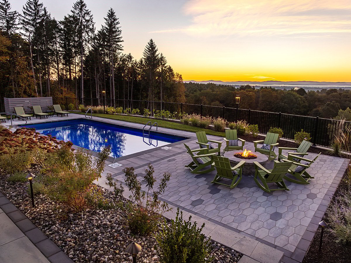 pool seating area and fire pit overlooking the new york horizon