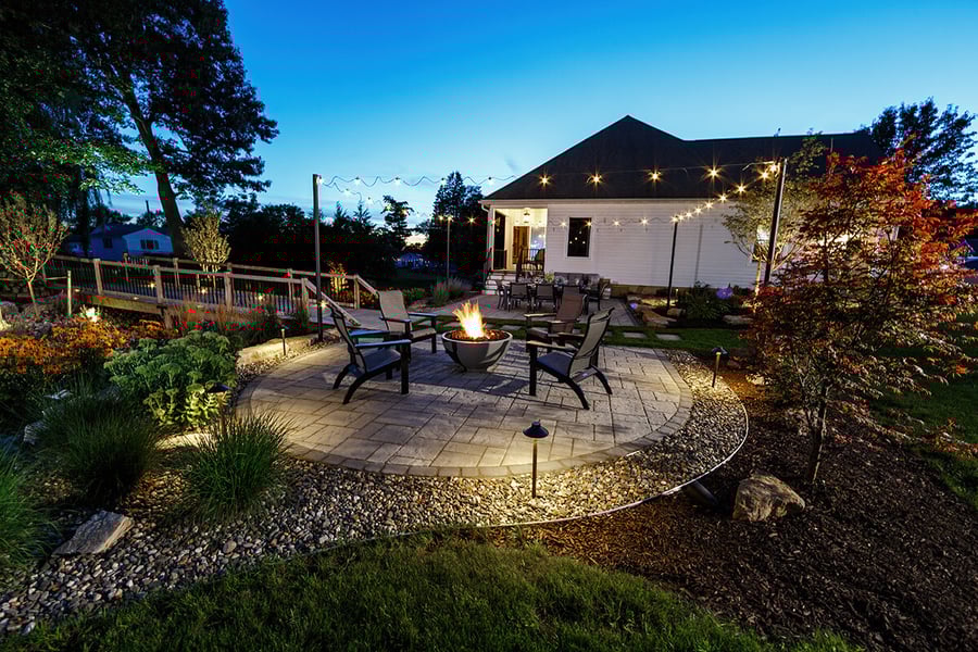 patio fire pit chairs seating lighting bistro lights planting beds bridge home vandervolgen