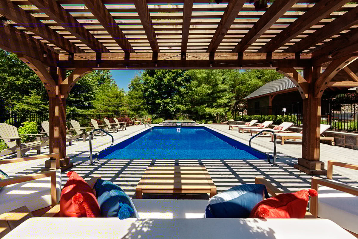 pergola seating by a pool