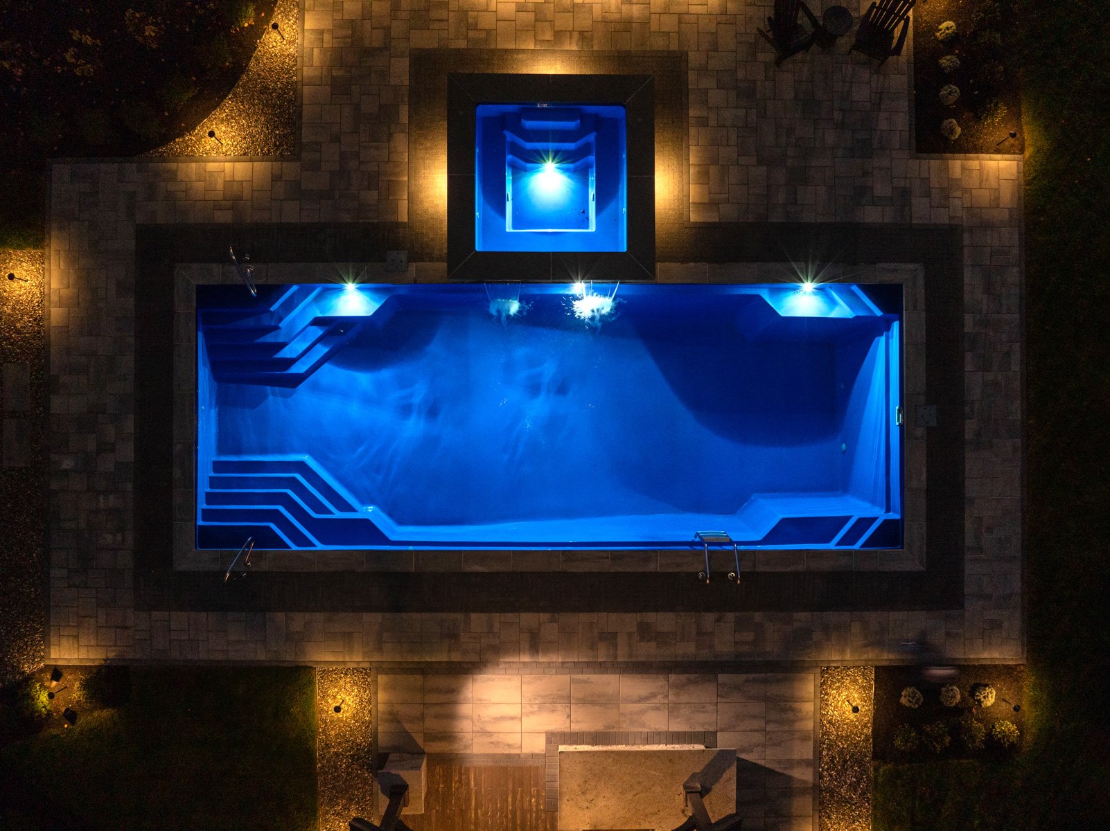 overhead of integrated pool and hot tub at night