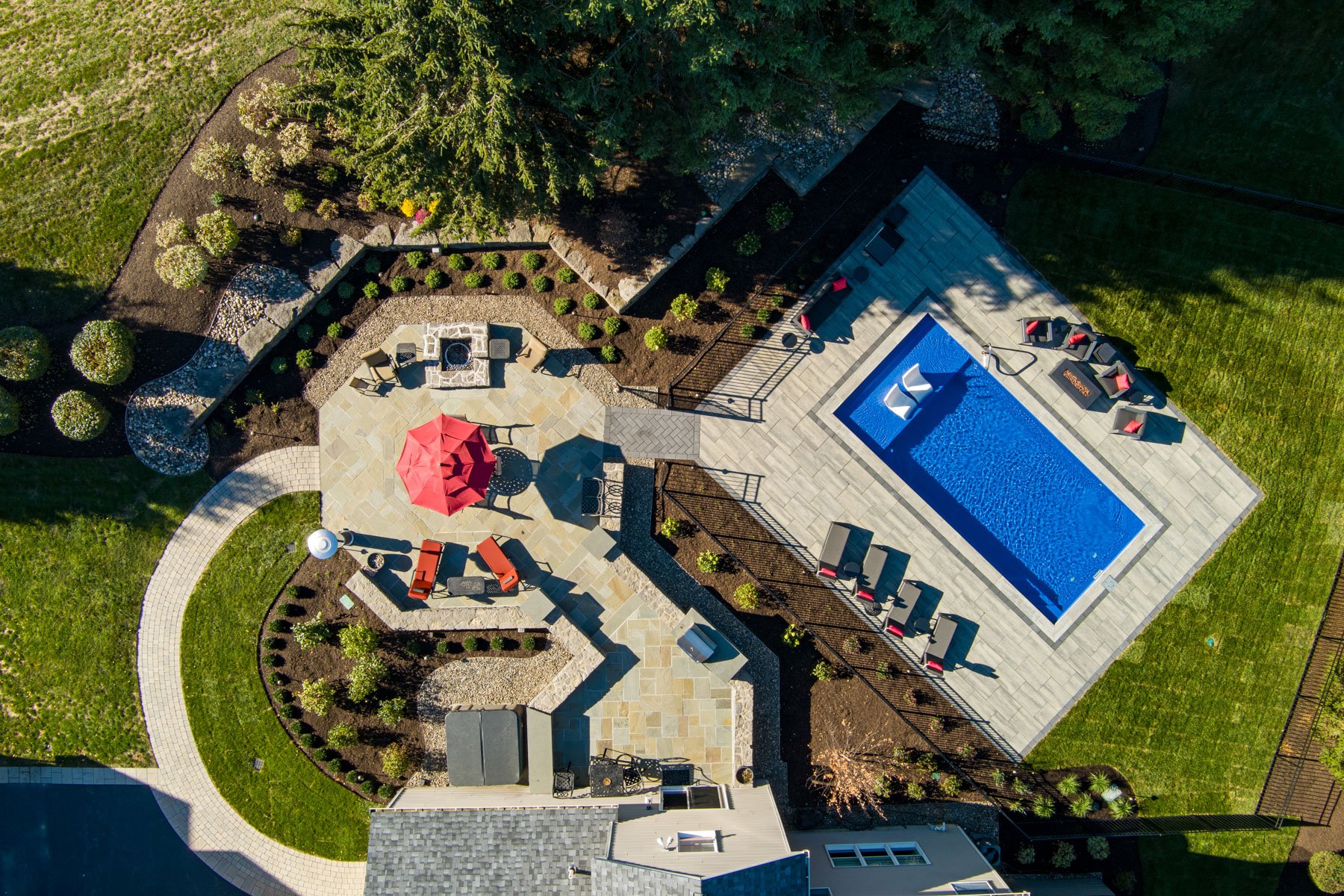 aerial view of a full backyard landscape including a pool
