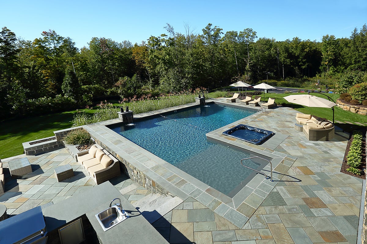 a pool area complete with seating and a spa