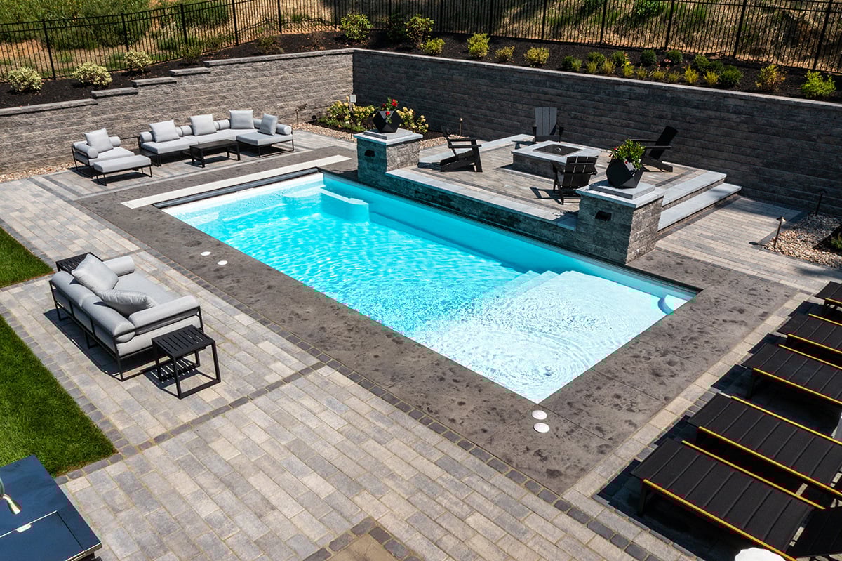 a stamped concrete border around a pool