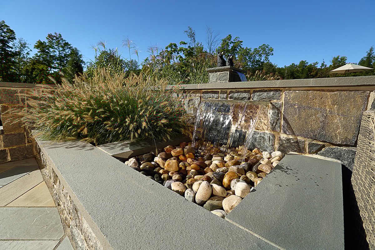 waterfall pouring into a gravel bed