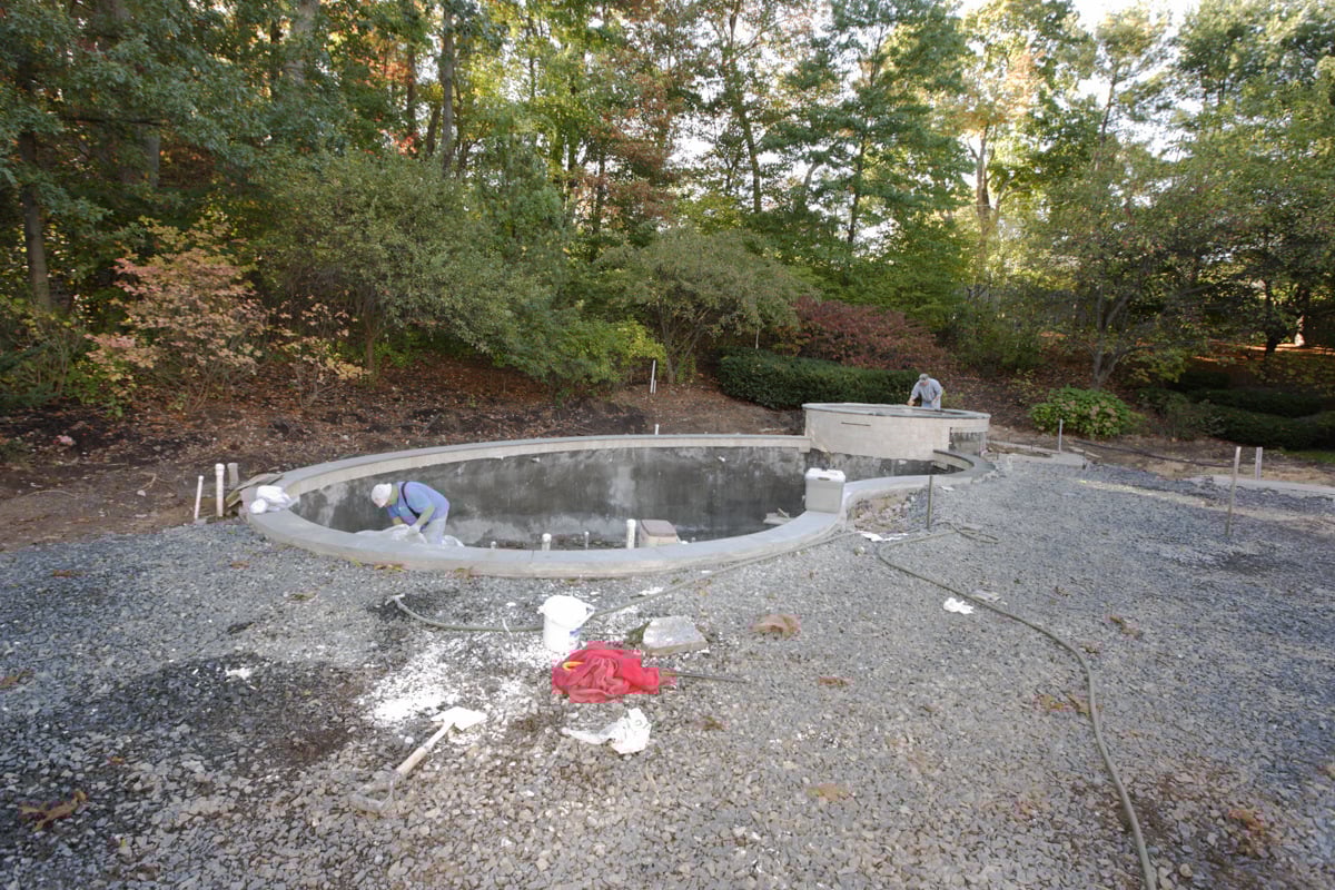 crew prepping an inground space for a fiberglass pool install