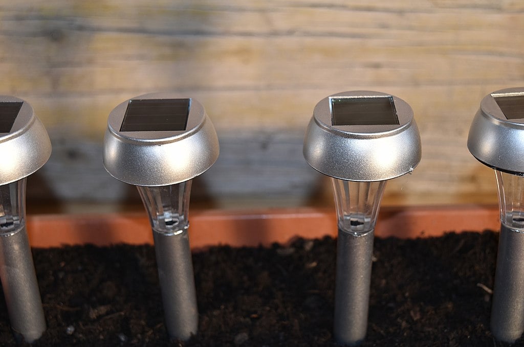 a line of solar powered landscape stake lights