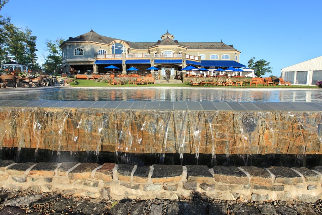 waterfall adding visual interest to the side of a pool