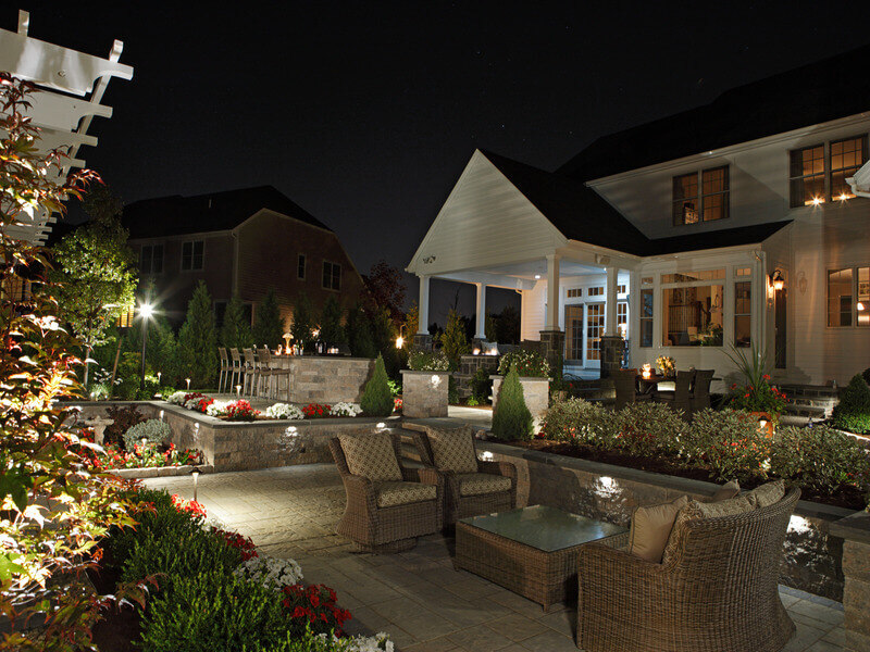 backyard space with various landscape lighting features