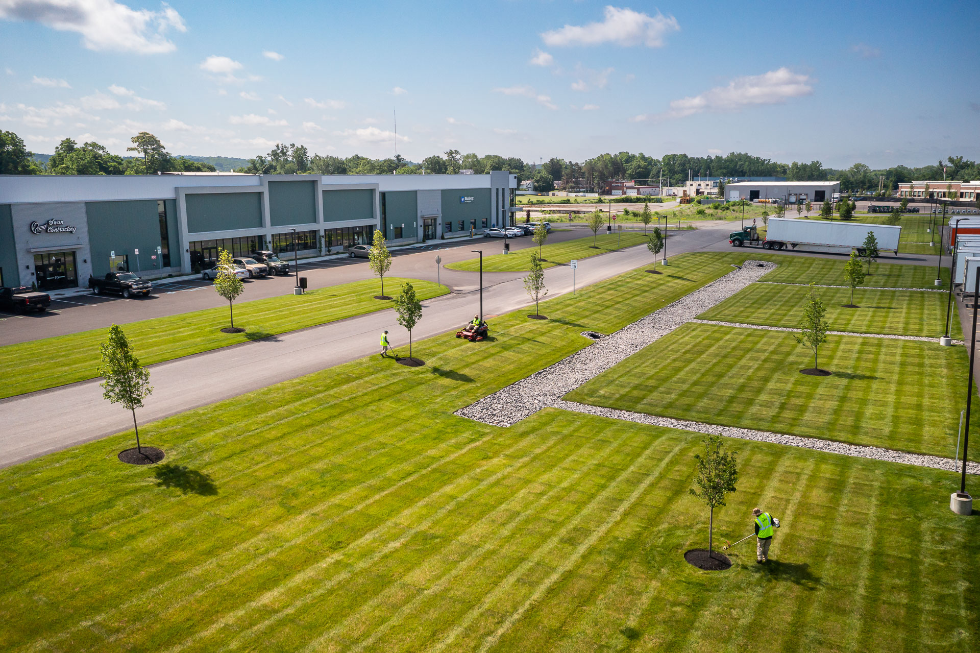 aerial commercial property maintenance line trimming tree ring mulch mowing