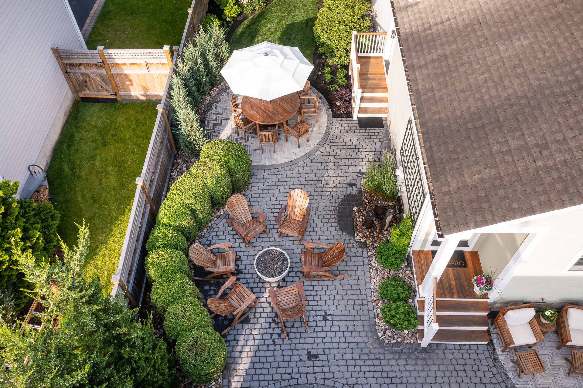 aerial paver patio firepit chairs seating water feature small backyard