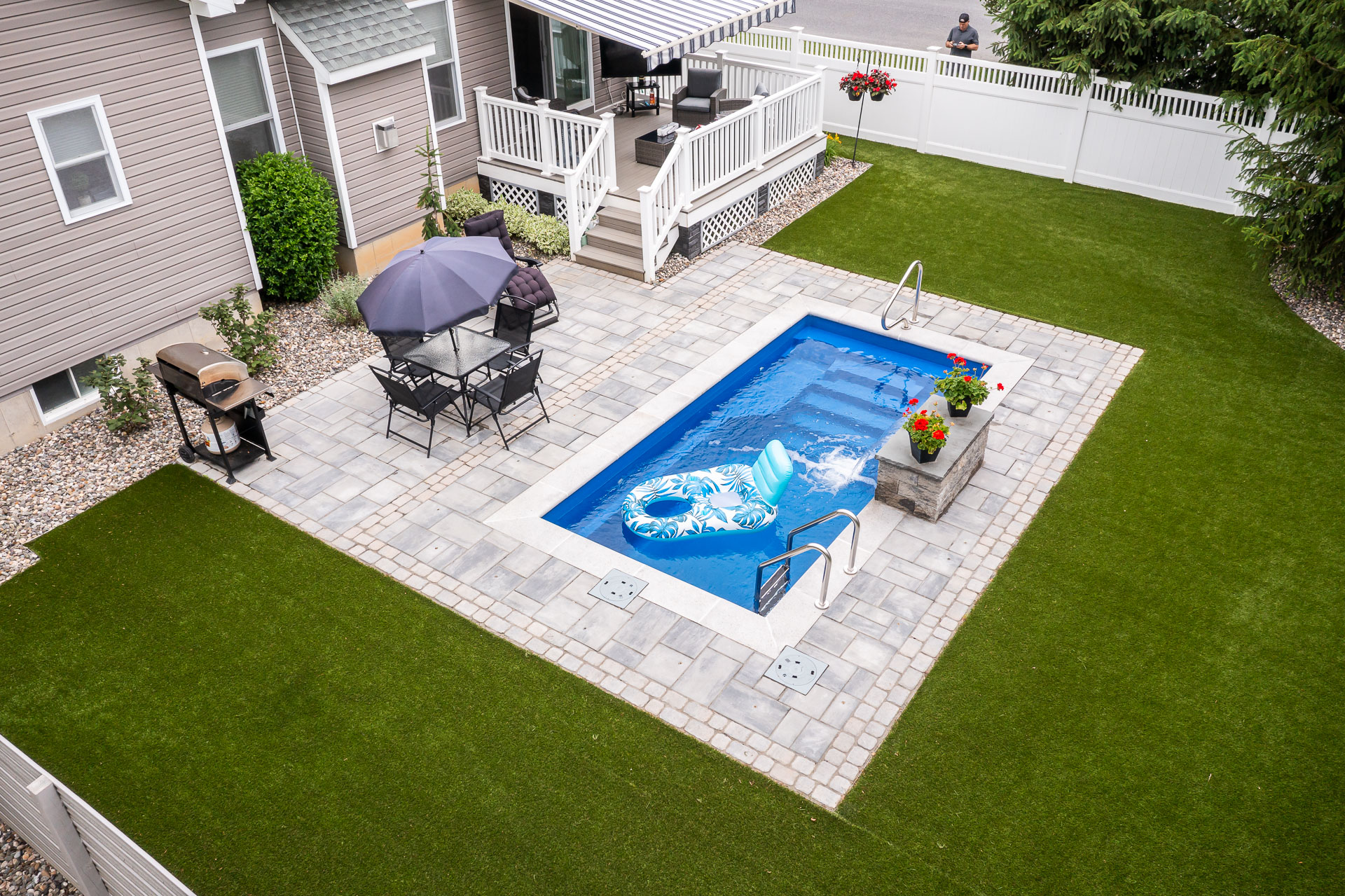 aerial small pool backyard arborvitae screening privacy shed synthetic turf gravel beds grill patio deck chairs awning mike 2