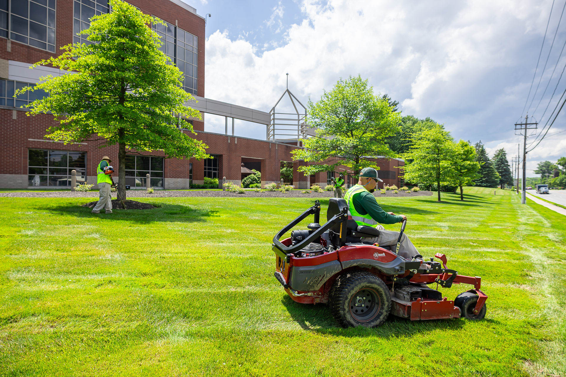 commercial crew line trimming mowing grass tree rings 2 3
