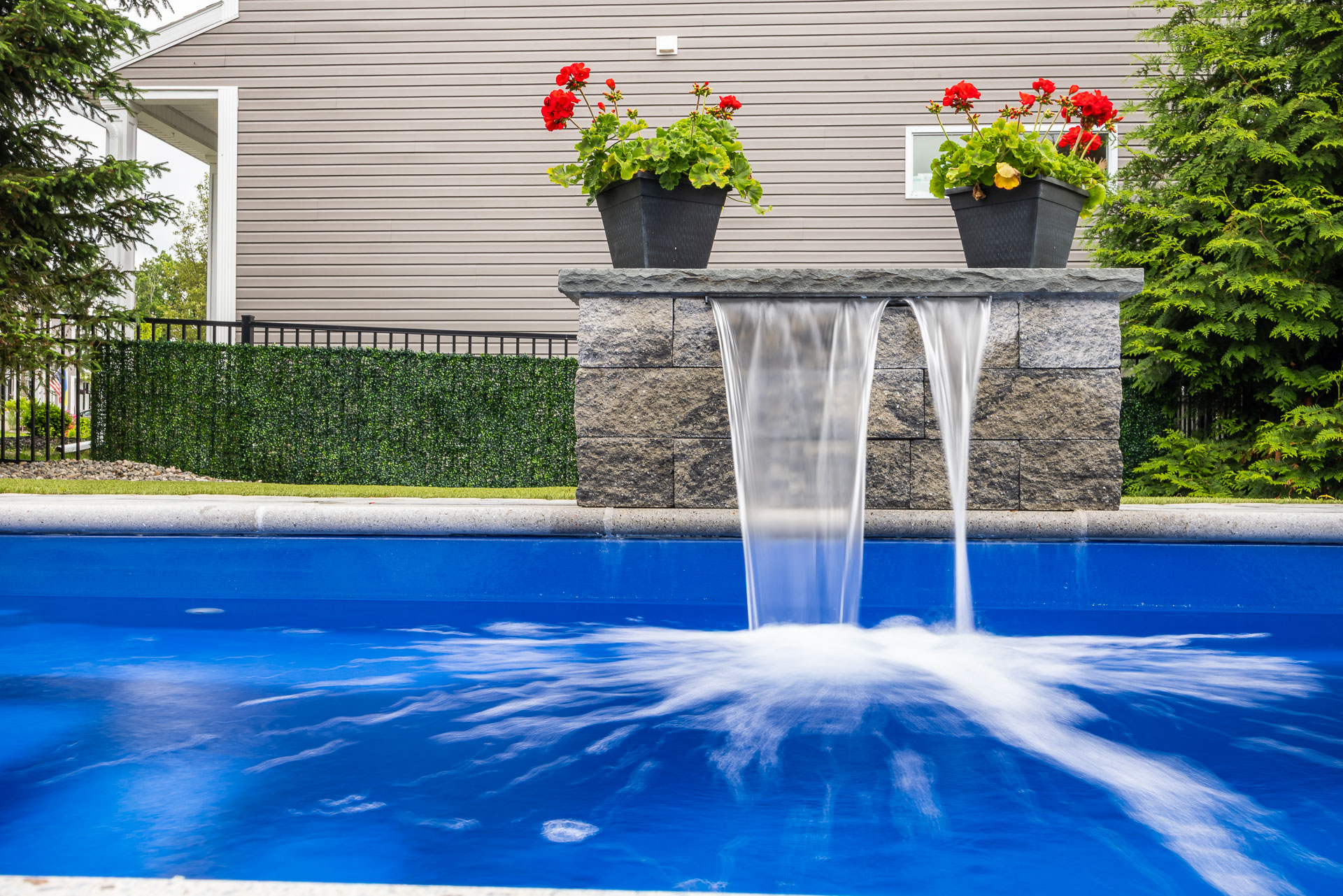 detail long exposure fountain scupper waterfall pool feature flowers 2