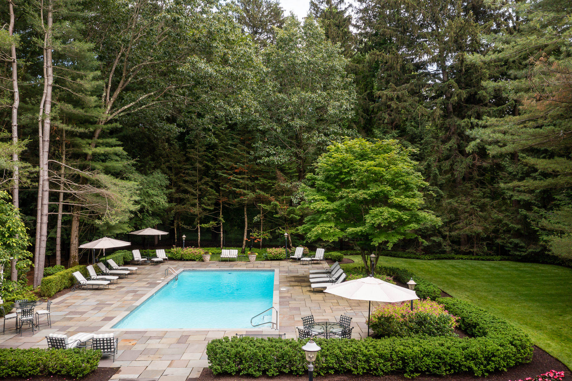 nice aerial pool patio deck seating planting hedge tree