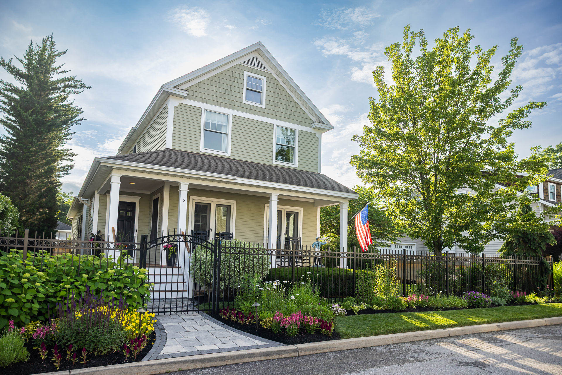nice home entry flowers planting beds grass rot iron fence paver path