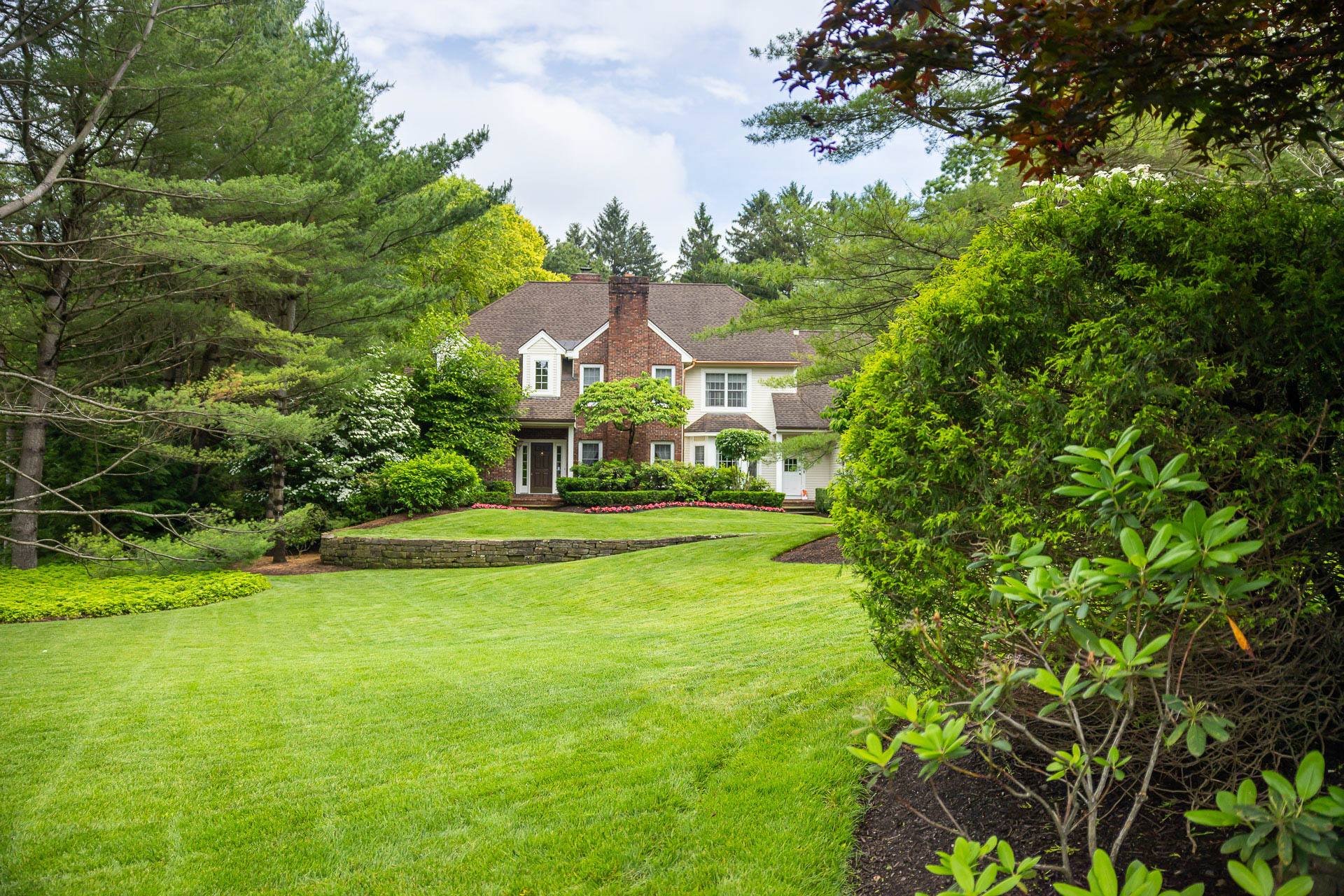 nice home green grass yard shrubs planting bed trees