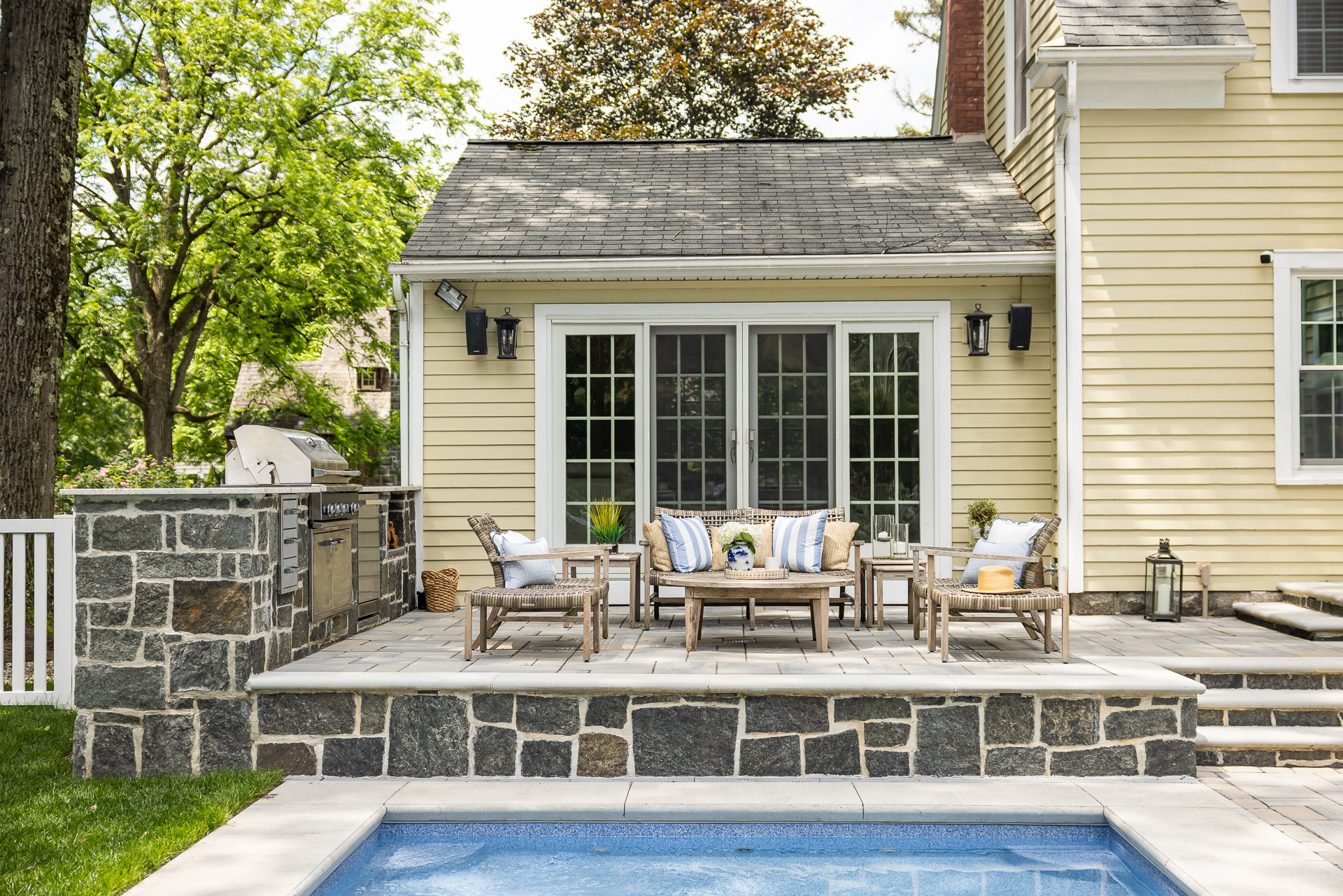 outdoor kitchen stone work pool seating patio