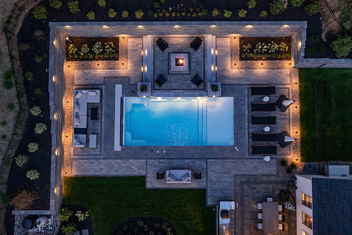 nice aerial pool lighting fire pit seating grass patio paver planting bed raval