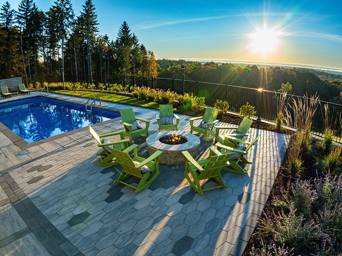 https://241926021.fs1.hubspotusercontent-na2.net/hubfs/241926021/Images/Client-Provided%20Images/patio%20seating%20fire%20pit%20porcelain%20plants%20fence%20sunrise%20pool%20mangini.jpg