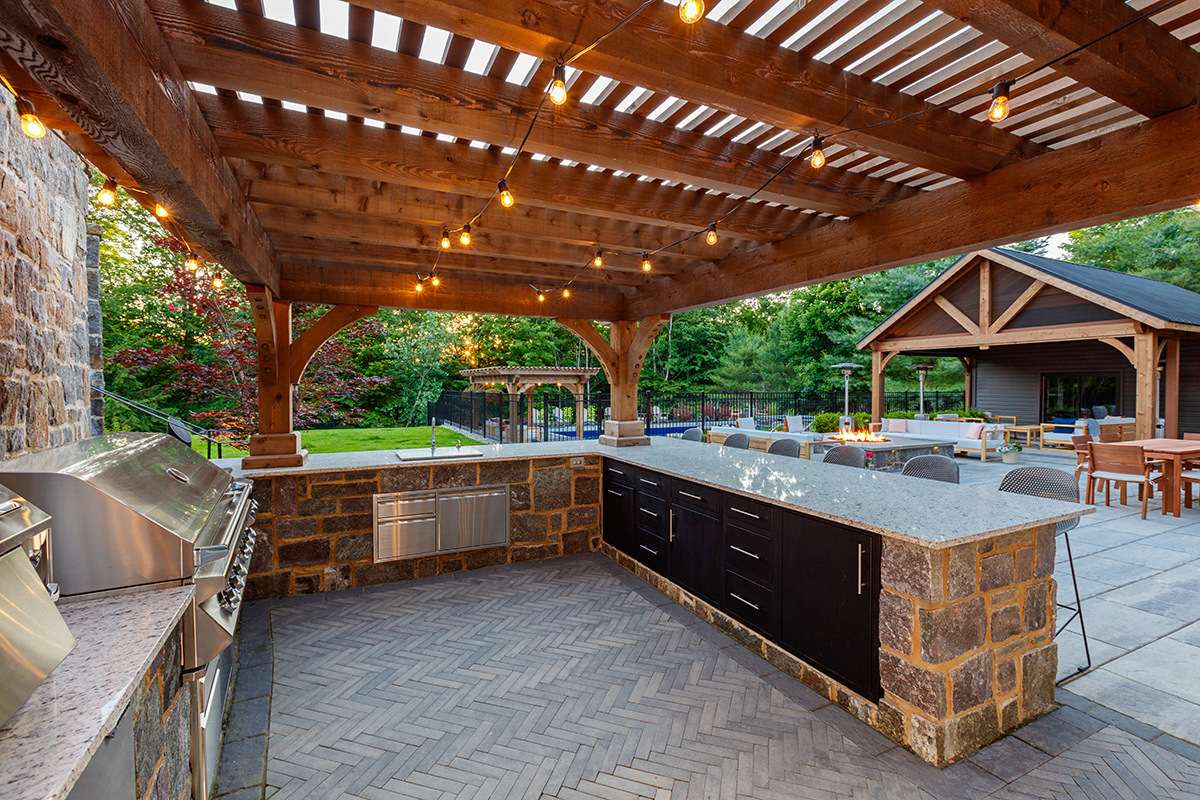 pergola lighting outdoor kitchen grill couter chairs patio paver demeo