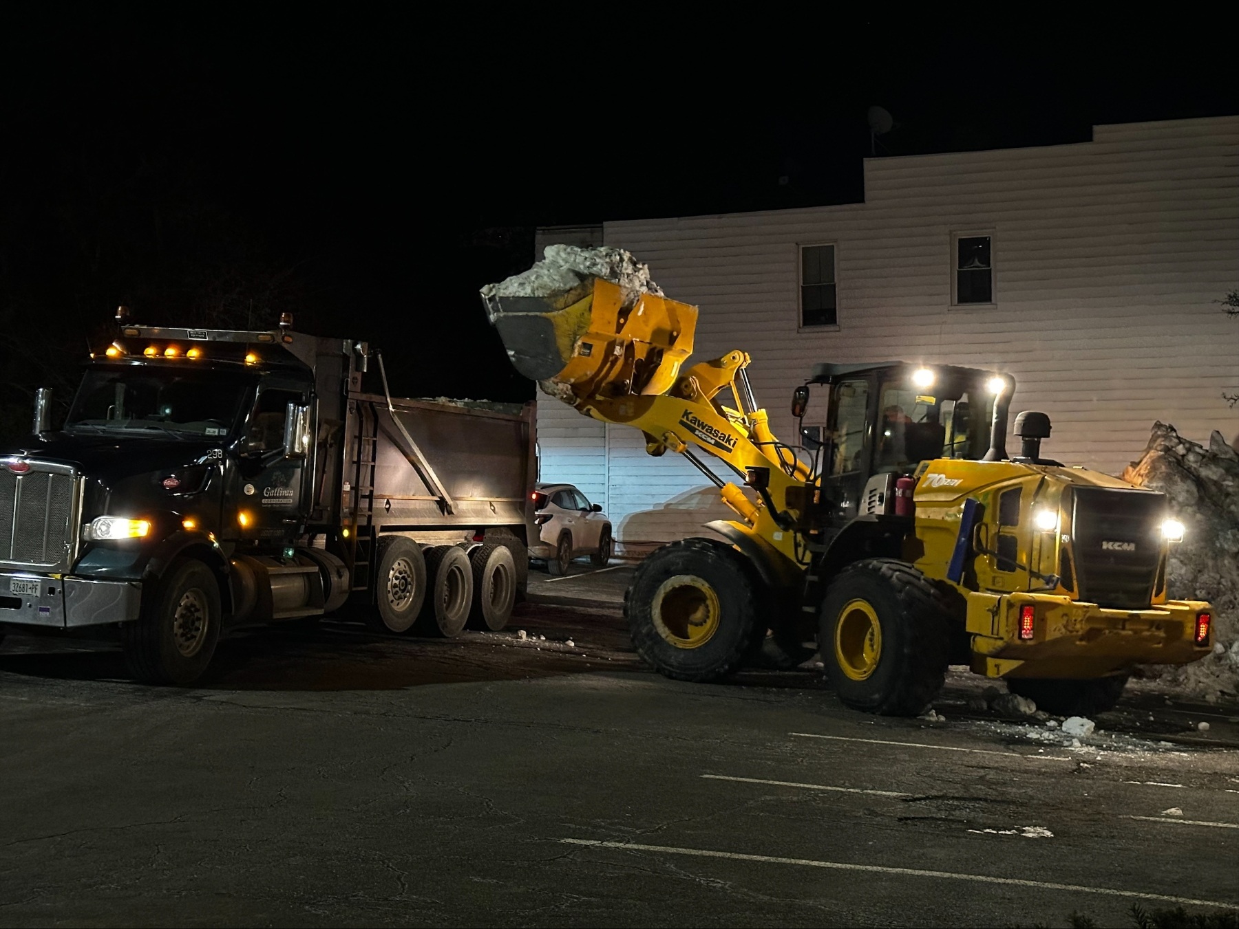 https://241926021.fs1.hubspotusercontent-na2.net/hubfs/241926021/Images/Client-Provided%20Images/snow%20removal%20relocation%20dump%20truck%20loader%20pile.jpg