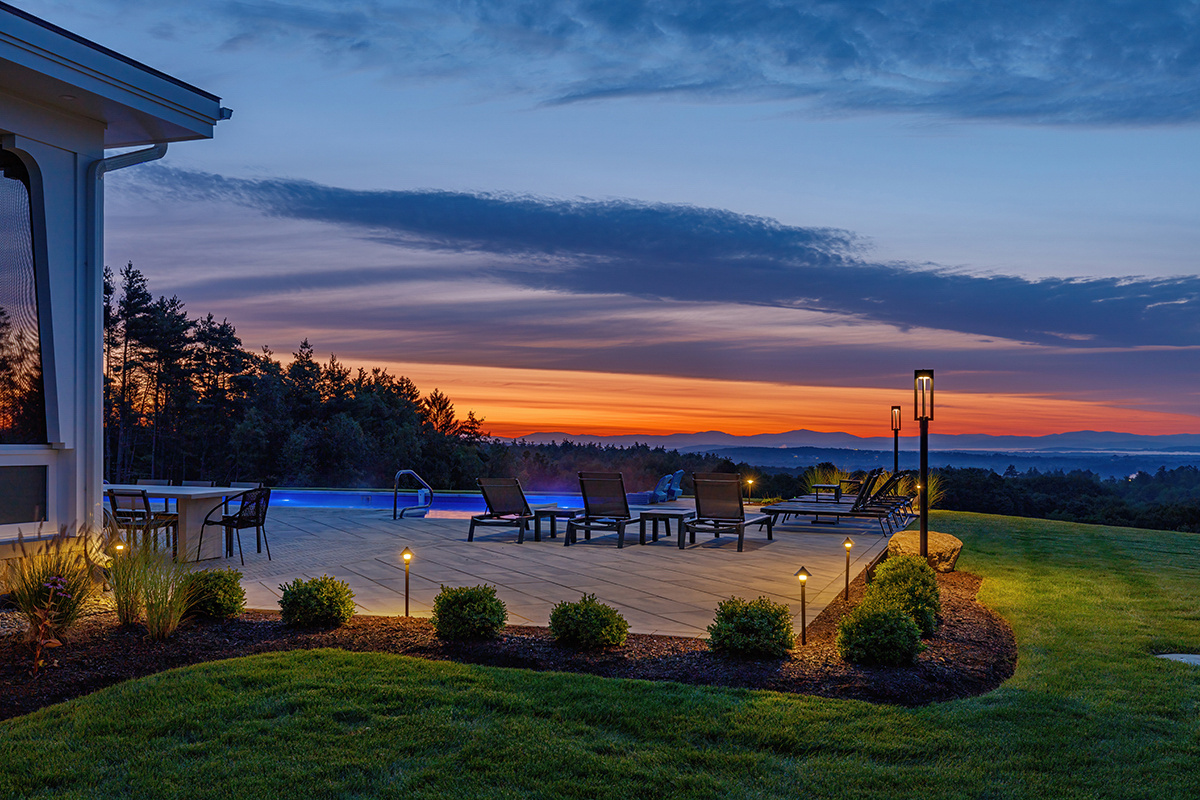https://241926021.fs1.hubspotusercontent-na2.net/hubfs/241926021/Images/Client-Provided%20Images/sunset%20lighting%20seating%20pool%20patio%20planting%20bed%20grass%20ohannlon.jpg